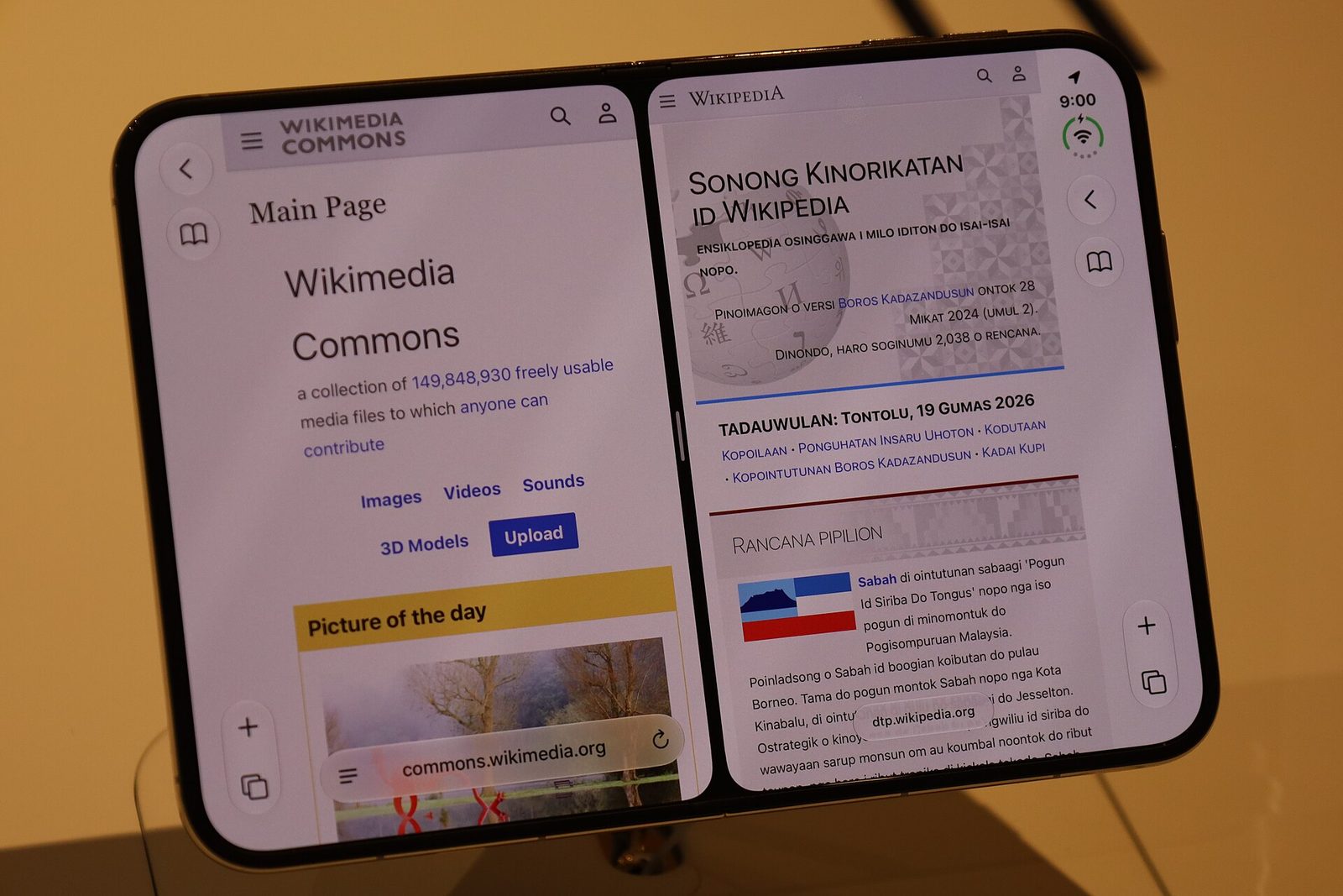 An opened iPhone Duo showing two apps side by side on its inner screen