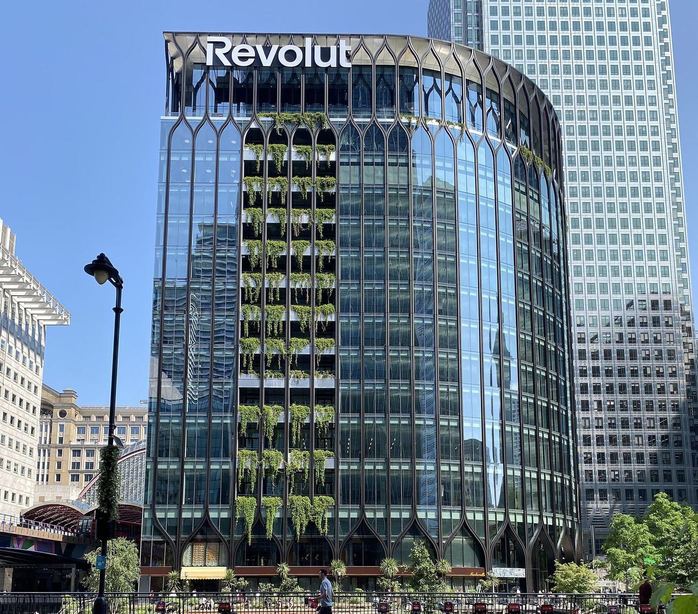 The Revolut head office building at Canary Wharf in London, with the company name on the facade.